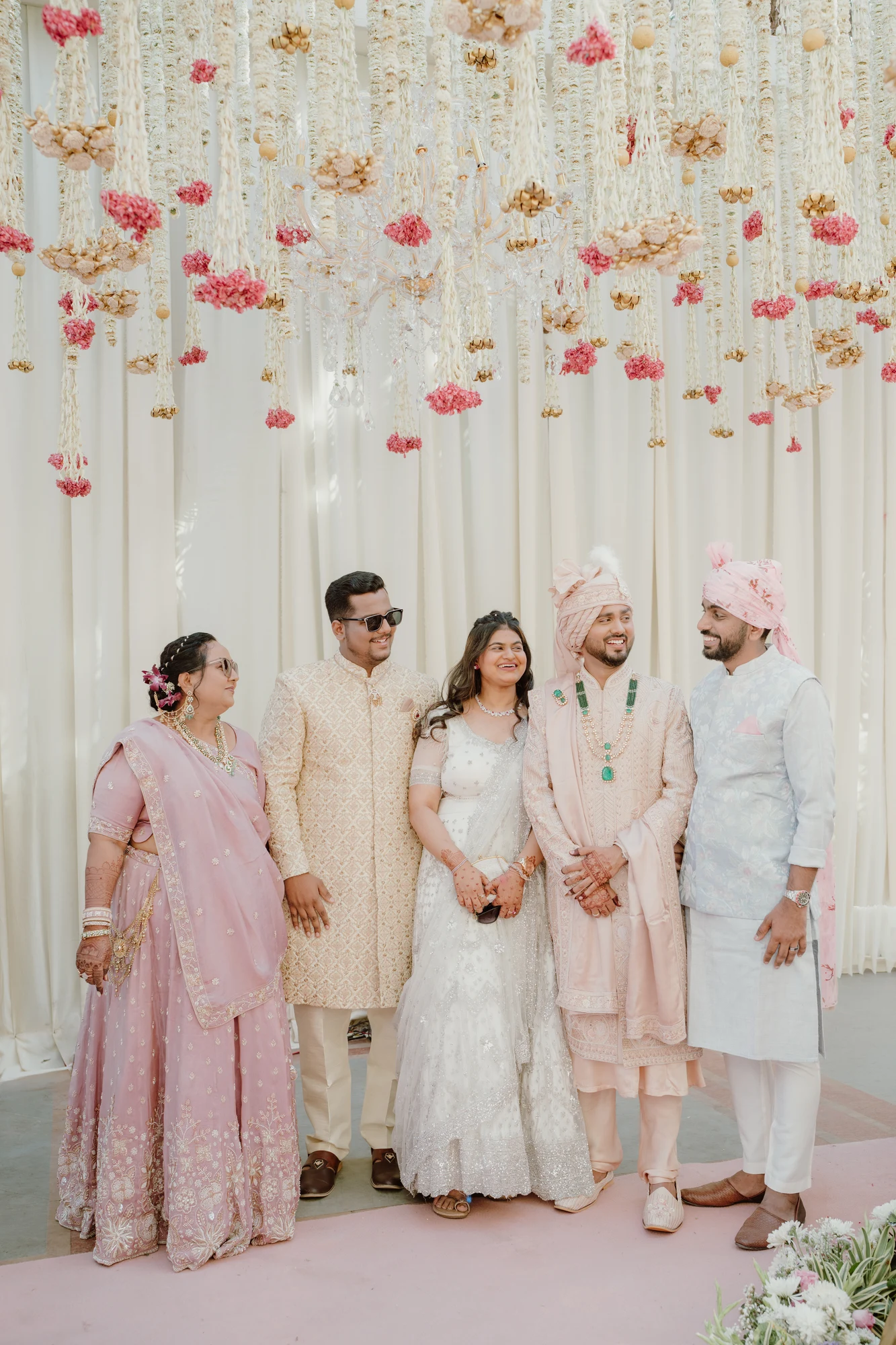 Wedding entourage celebration under floral canopy
